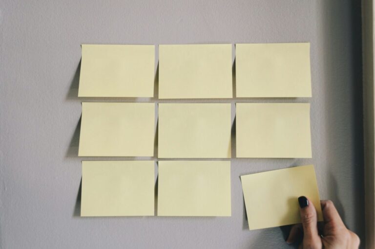 Hand adding a sticky note to an existing grid